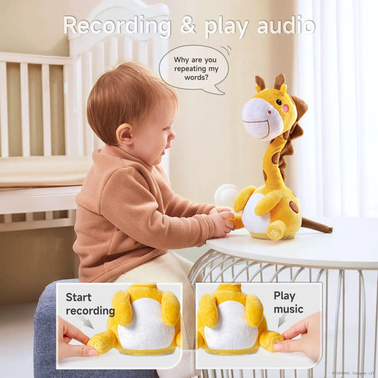 A baby sitting at a table interacting with a yellow giraffe plush toy that can record and play audio; the toy features labeled buttons for recording and playing music.