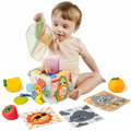 Baby playing with a Montessori tissue box toy, surrounded by soft fruit toys and animal-themed cloth cards, ideal for sensory development and early learning.