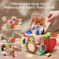 Montessori pretend play tissue box toy for sensory stimulation, featuring colorful cloth tissues, soft fruit toys, and multiple interactive sides, designed to encourage imaginative play and early childhood development.