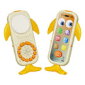 Two whale-shaped baby toy phones with yellow fins and tails, featuring orange buttons and a cartoon-style screen with colorful app icons. One toy displays the front speaker and buttons, while the other shows the screen interface.