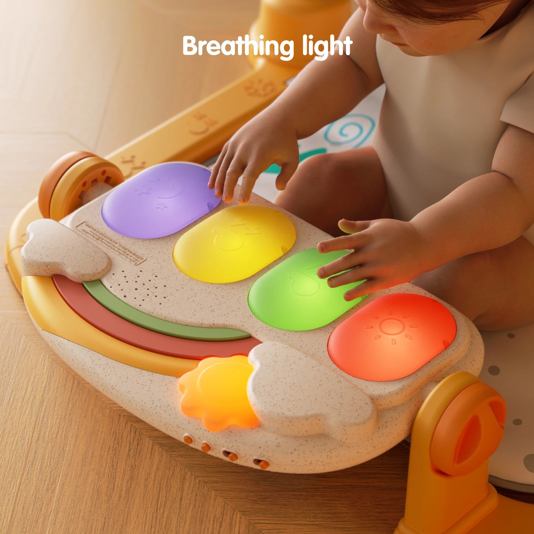 Baby playing with Tumama rainbow piano keyboard on baby gym, colorful breathing light keys glowing in red, green, yellow, and purple for interactive music play.