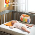 Baby lying in crib with Tumama rainbow piano used independently as a musical cot toy, colorful keyboard soothing infant to sleep.