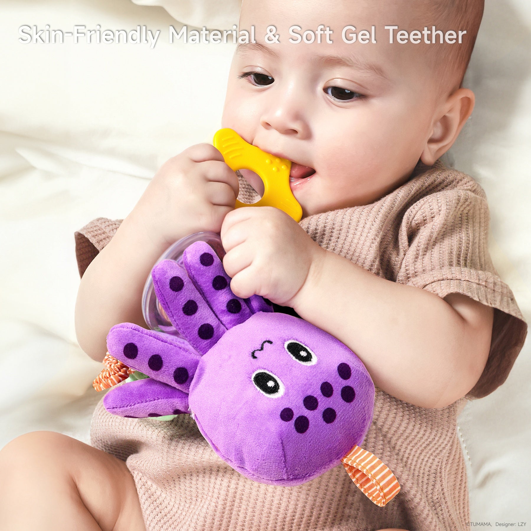 Close-up of a baby lying down and chewing on a yellow soft gel teether attached to a purple plush octopus toy. The baby is wearing a brown ribbed onesie, and the text overlay reads: "Skin-Friendly Material & Soft Gel Teether."