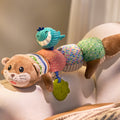 Video shows baby playing with multi-functional otter-shaped sensory toy, featuring a cute blue whale teether and green leaf-shaped teether attachment. Toy is made of colorful fabric segments and includes a brown plush head, multi-color patterned body and tail.