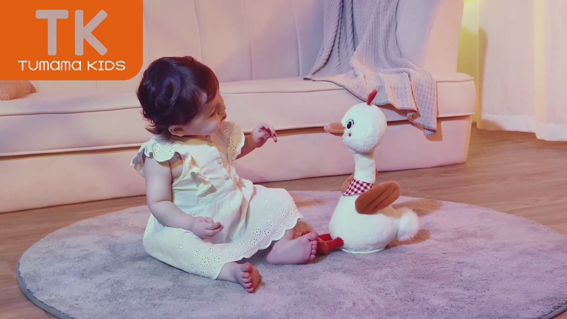 Video of baby girl playing with plush duck toy that moves neck and sings